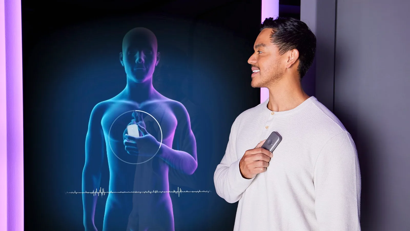 Person holding a Forward body-scan device beside a holographic scan